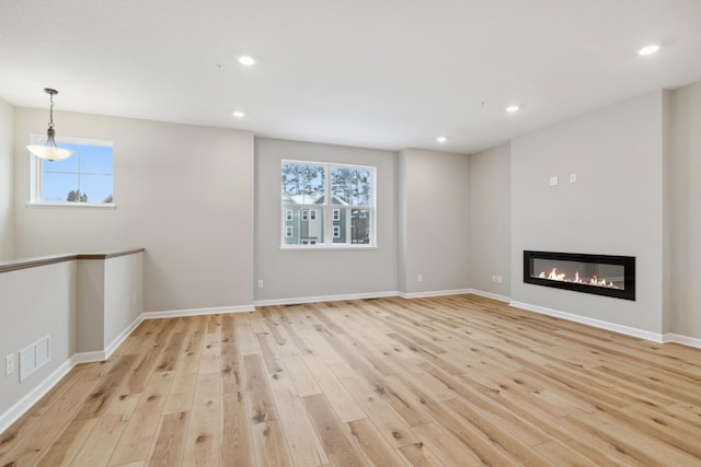 unfurnished living room featuring light wood-type flooring