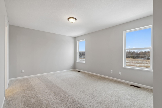 unfurnished room featuring carpet