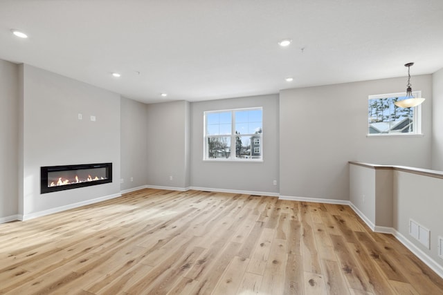 unfurnished living room with light hardwood / wood-style floors