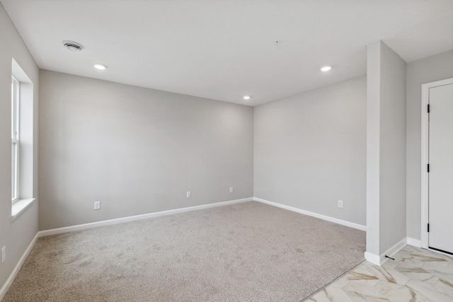 empty room featuring light colored carpet