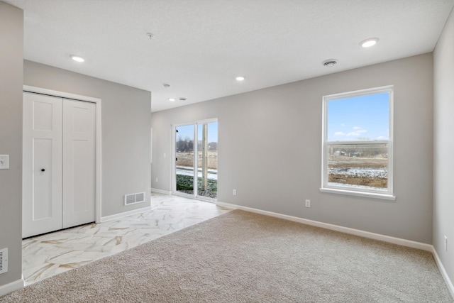 spare room with light colored carpet