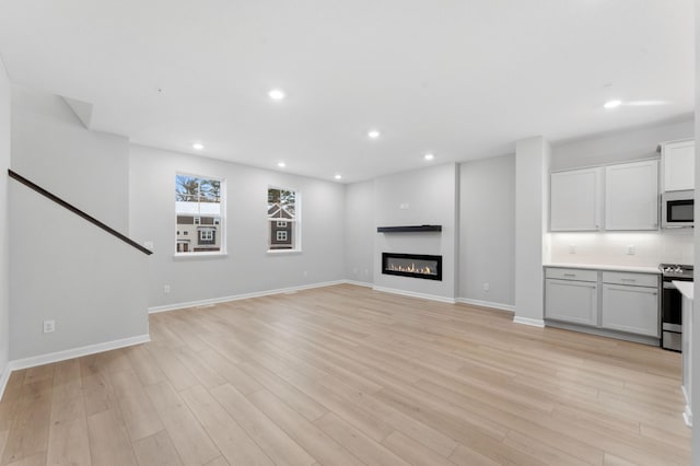 unfurnished living room with light hardwood / wood-style floors