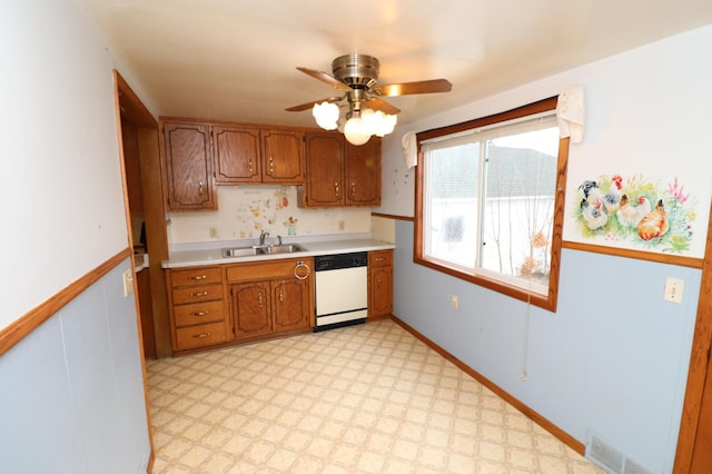 kitchen with white dishwasher, sink, and ceiling fan