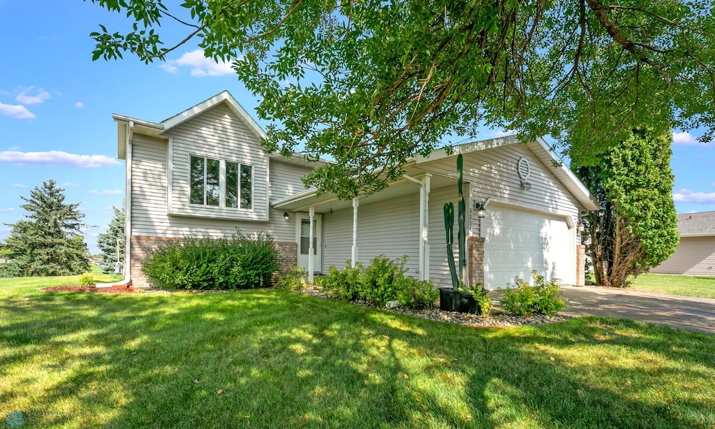 view of front of home with a garage and a front lawn