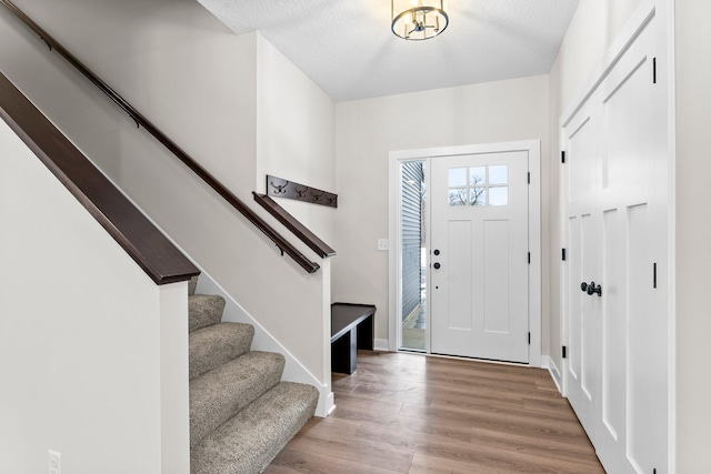 foyer featuring hardwood / wood-style floors and a textured ceiling