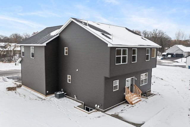 view of snowy exterior with cooling unit