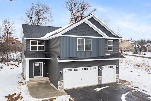 craftsman house with a garage, stone siding, aphalt driveway, and a shingled roof