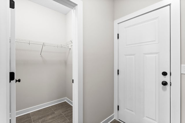 interior space with dark wood-style floors and baseboards