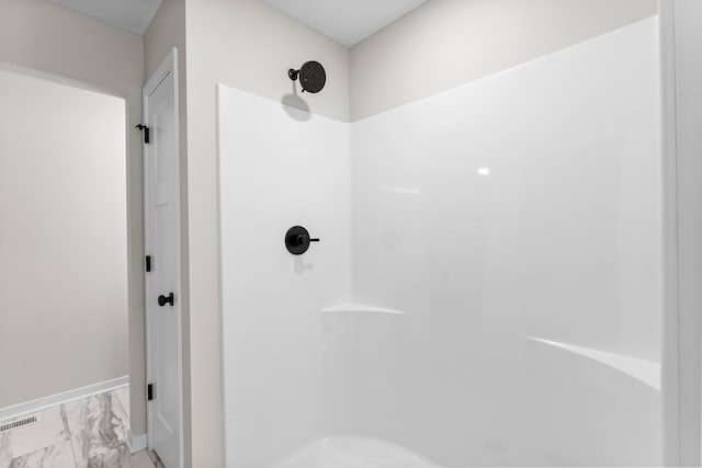 full bath featuring marble finish floor, walk in shower, visible vents, and baseboards