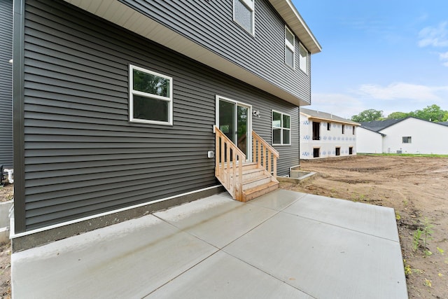 19498 Carson Ct NW, Elk River, MN 55330 - rear view of property with entry steps and a patio