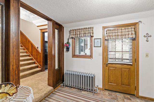 13640 Hagedorn Rd NW, Brandon, MN 56315 - foyer featuring radiator, baseboards, a textured ceiling, and stairs