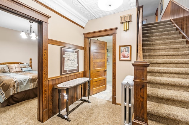 13640 Hagedorn Rd NW, Brandon, MN 56315 - interior space with an ornate ceiling, a wainscoted wall, light colored carpet, wood walls, and a notable chandelier