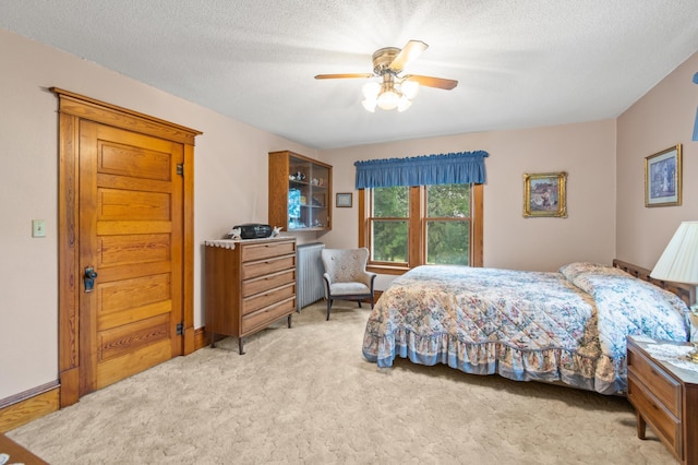 13640 Hagedorn Rd NW, Brandon, MN 56315 - bedroom featuring radiator heating unit, a textured ceiling, ceiling fan, and light carpet