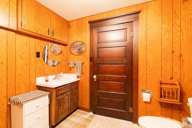 13640 Hagedorn Rd NW, Brandon, MN 56315 - half bath with a textured ceiling, toilet, vanity, and wood walls