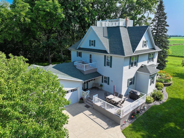 13640 Hagedorn Rd NW, Brandon, MN 56315 - back of property with a chimney, a balcony, an attached garage, driveway, and a lawn