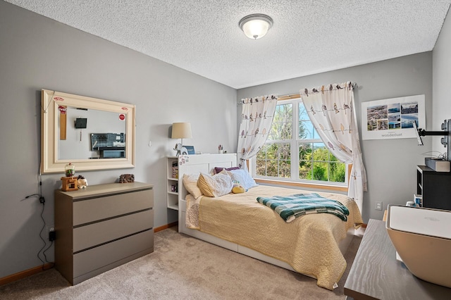 bedroom featuring carpet flooring, a textured ceiling, and baseboards