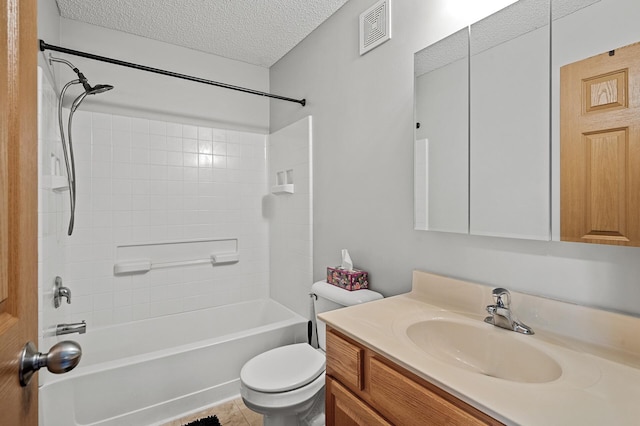 full bathroom featuring a textured ceiling, tiled shower / bath, vanity, and toilet