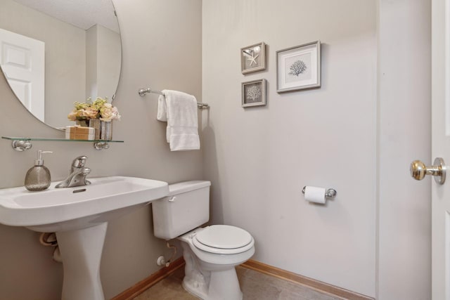 bathroom featuring tile patterned floors, a textured ceiling, and toilet