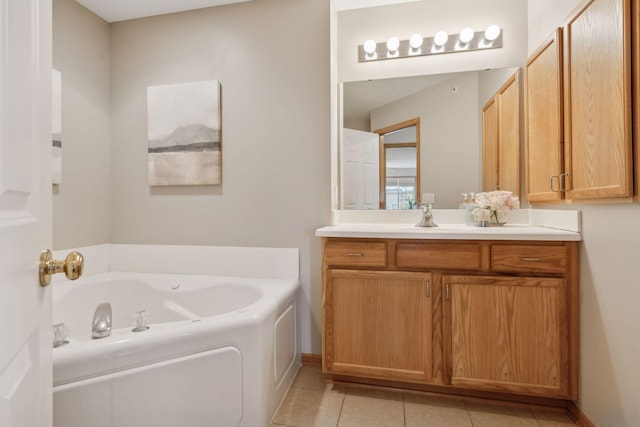 bathroom with a bathing tub, tile patterned flooring, and vanity