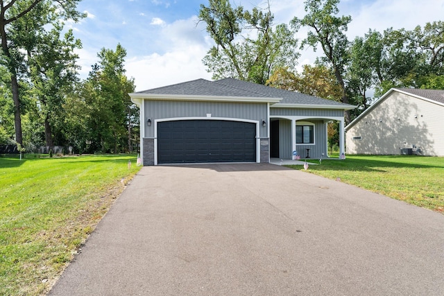 view of front of property featuring a garage and a front yard