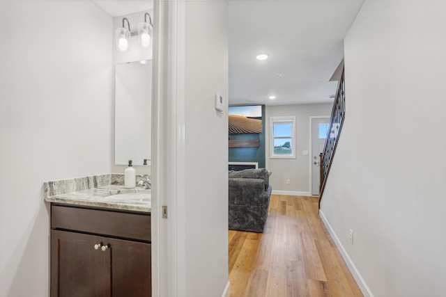 interior space with vanity and hardwood / wood-style flooring