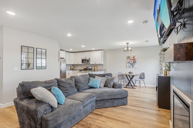 living room featuring light hardwood / wood-style floors and sink