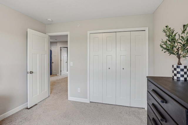 carpeted bedroom featuring a closet