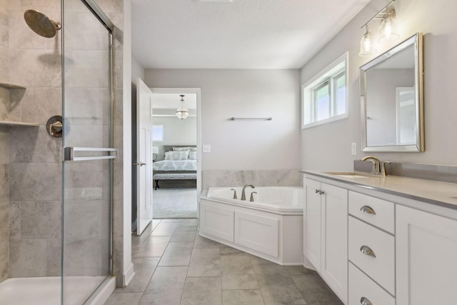 ensuite bathroom with ensuite bathroom, a shower stall, vanity, tile patterned flooring, and a bath