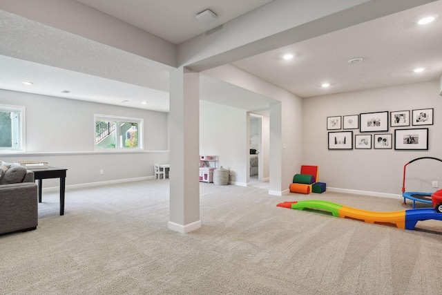 recreation room with light carpet, recessed lighting, and baseboards