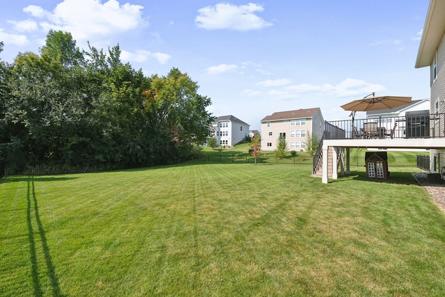 view of yard featuring a fenced backyard, stairway, and a deck