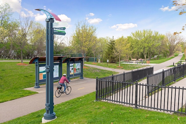 view of community with a yard and fence