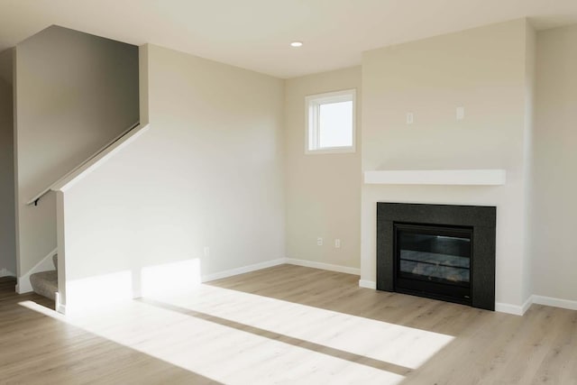 unfurnished living room with light wood-type flooring