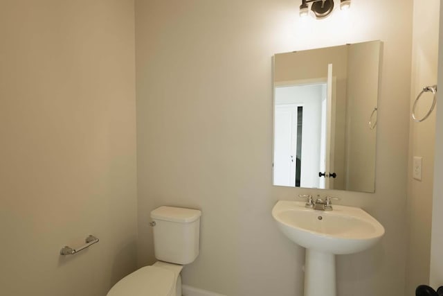 bathroom featuring sink and toilet