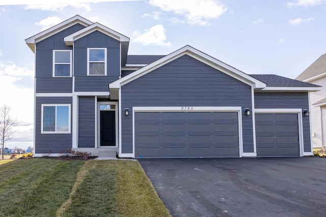 view of front of home featuring a front yard and a garage