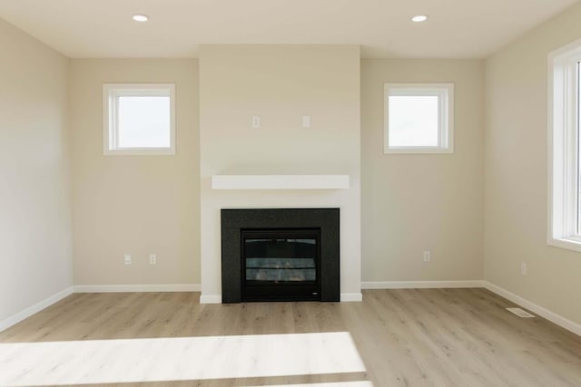 unfurnished living room featuring light hardwood / wood-style flooring