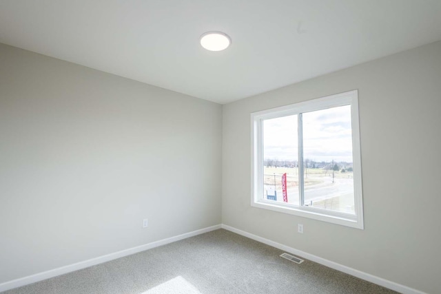 unfurnished room featuring carpet flooring