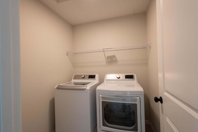 laundry room with independent washer and dryer