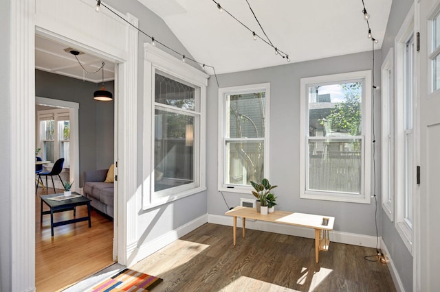 sunroom / solarium featuring vaulted ceiling and plenty of natural light