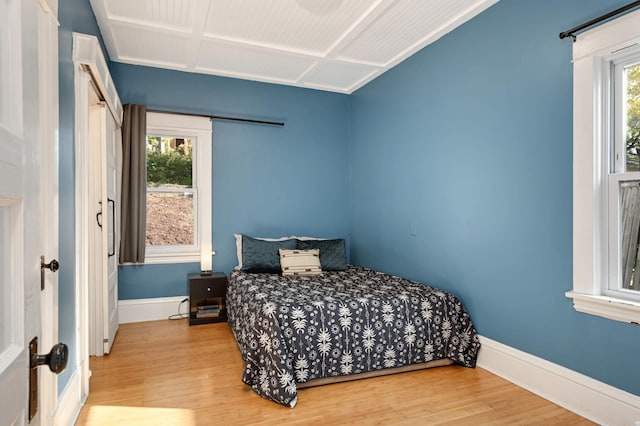 bedroom featuring multiple windows and hardwood / wood-style flooring