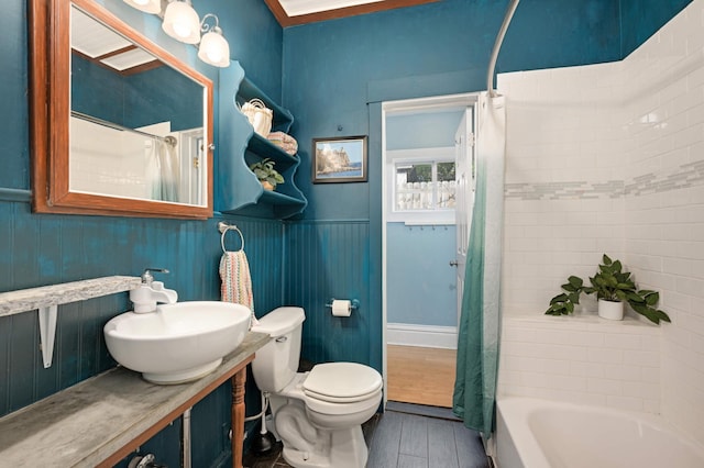 full bathroom featuring toilet, vanity, hardwood / wood-style floors, and shower / bath combination with curtain