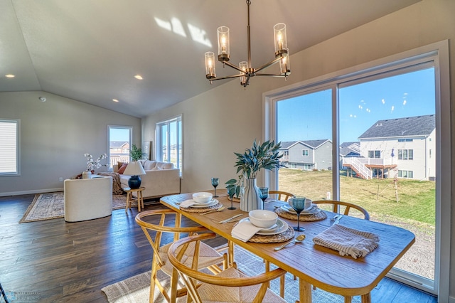 dining room featuring lofted ceiling, hardwood / wood-style floors, and a notable chandelier