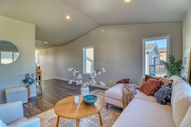 living room with dark wood-type flooring and vaulted ceiling