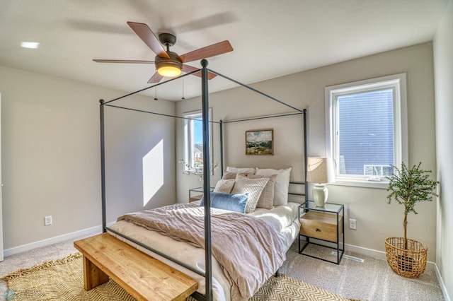 bedroom with ceiling fan and light carpet