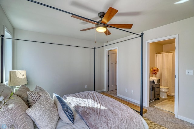 carpeted bedroom featuring ensuite bath and ceiling fan