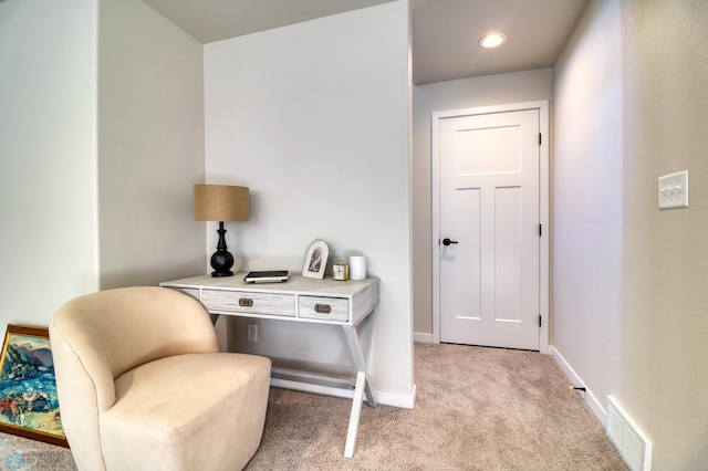 sitting room featuring light colored carpet