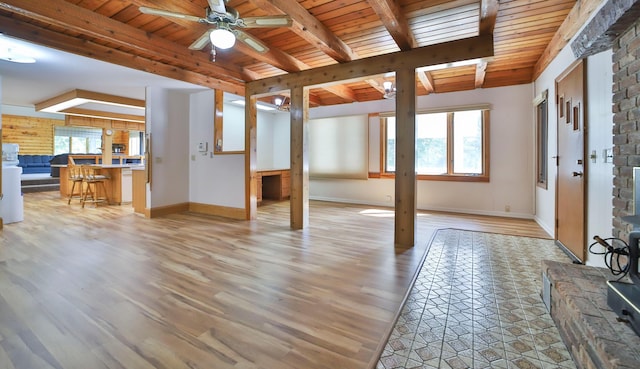 interior space featuring a wealth of natural light, beam ceiling, light wood-type flooring, and a ceiling fan