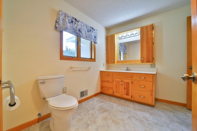 bathroom with visible vents, toilet, a textured ceiling, baseboards, and vanity