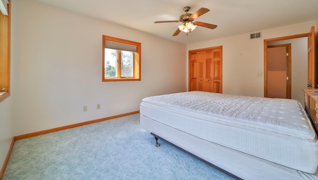 bedroom with visible vents, a ceiling fan, a closet, carpet floors, and baseboards