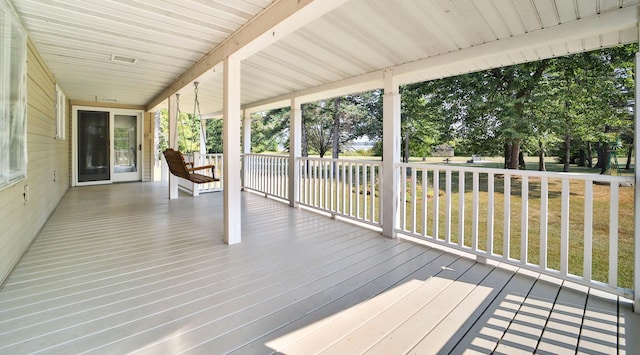 wooden deck featuring a yard