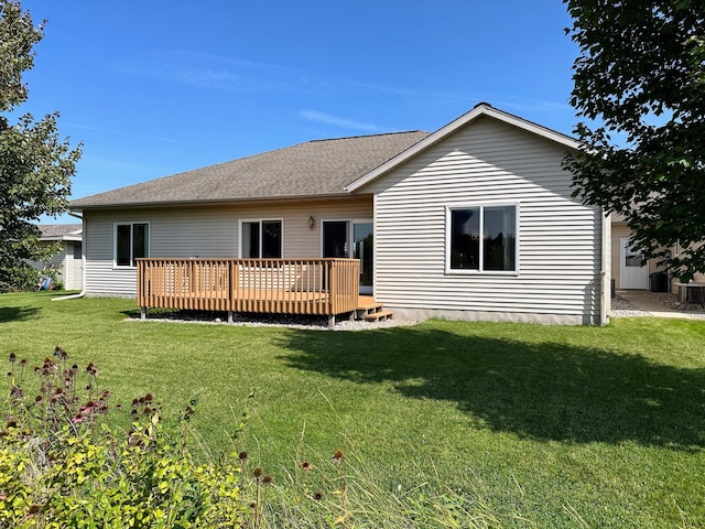 rear view of property with a lawn and a wooden deck